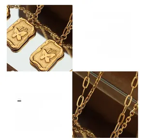 Macro detail of 18K gold plated square pendant with embossed butterfly on titanium steel