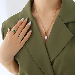 Elegant gold chain necklace with rectangle shell pendant and emerald gemstone ring