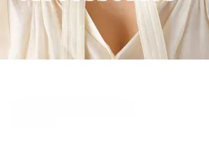 Detailed macro view of cream satin blouse featuring V-neck and silky metallic luster texture