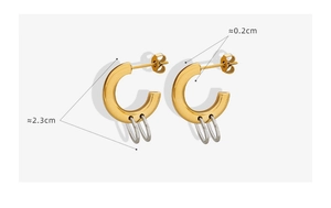 Detailed view of two-tone C-shape interlocking earrings with 2.3cm diameter gold and silver