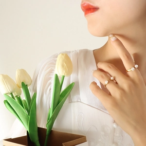 Baroque natural freshwater pearl U-shaped open gold rings worn by model with flowers