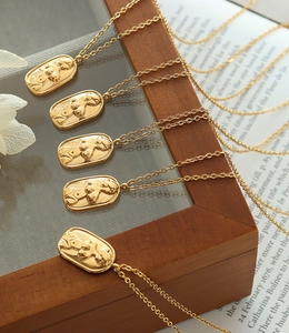 Detailed view of vintage gold oval pendant with feminine silhouette relief on O-chain