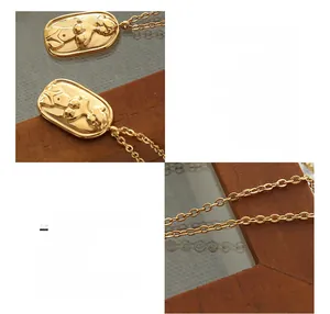 Macro detail of the 18K gold plated oval relief portrait pendant and O-chain texture