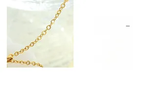 Detailed close-up of the polished gold-plated O-chain link structure and smooth metallic texture