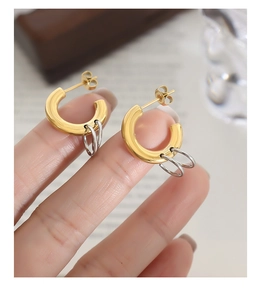 Detailed shot of gold and silver interlocking hoop earrings in minimalist bicolor design