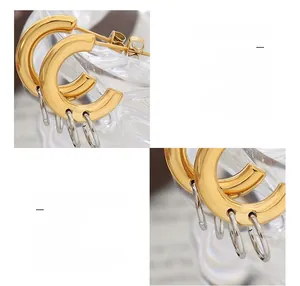 Macro shot of 18K gold plated titanium steel C-hoops with silver dangling ring accents