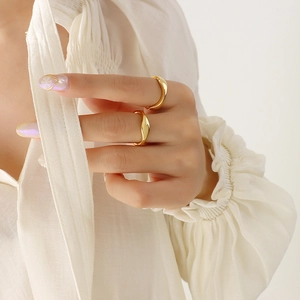 Minimalist wave gold rings in mirror polished 18k finish worn as stackable jewelry