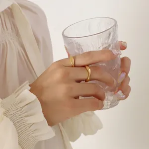 Minimalist 18k gold plated stainless steel wavy ring set worn in a lifestyle setting