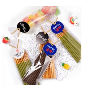 Detail of DIY snack packaging with cute gift tags and ribbons on white lace