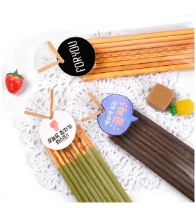 Close-up of decorative cookie packaging with gold twist ties and Korean gift cards