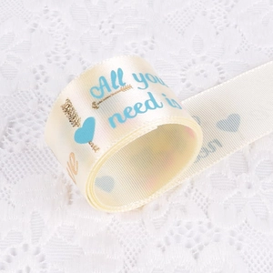 Cream satin ribbon with blue and gold 'All you need is love' print for gift wrapping