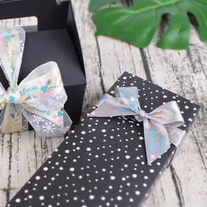 Detail of luxury gift boxes with decorative satin ribbons and golden Love lettering