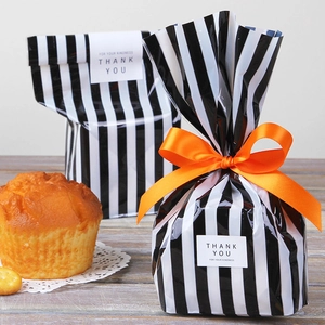 Black and white striped gift bag with bright orange ribbon and Thank You label decoration