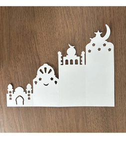 Detailed laser-cut white cardstock with a pop-up 3D mosque and crescent moon design