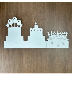 Macro view of white 3D pop-up card featuring laser-cut cake and Happy Day text