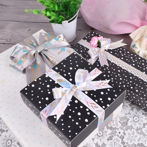 Satin ribbon rolls for gift wrapping and DIY crafts featuring heart and feather patterns