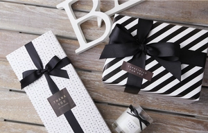 Detail of polyester grosgrain ribbon on black and white gift boxes with labels