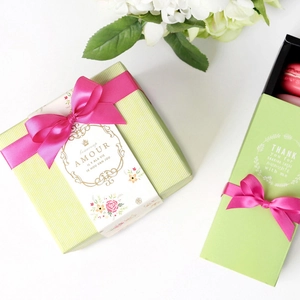 10mm magenta ribbon on green gift boxes with floral patterns and pink macarons