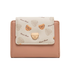 Detailed close-up of a pink cartoon bear wallet with a golden bear metal buckle clasp