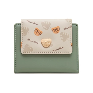 Detail of compact women's wallet with cartoon bear print and gold bear metal clasp