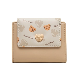 Detail of cute bear gold buckle and cartoon print on cream-colored foldable women's wallet