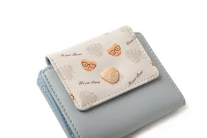 Detail view of Wiser Bear blue PU leather wallet with metallic bear badge and stitching