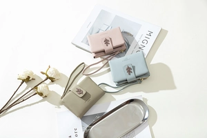 Short women's wallets in pastel colors with leaf buckles and matching hand straps