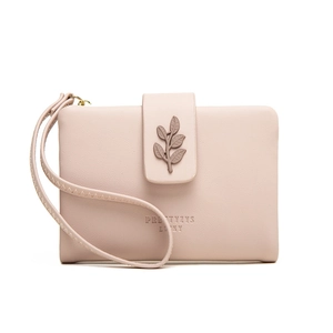 Detail of light pink leather wallet featuring a decorative leaf clasp and wrist strap