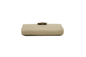 Side view of light grey pebbled leather wallet showing leaf buckle and edge craftsmanship