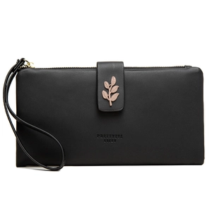 Detail of black faux leather wallet with gold leaf buckle and lucky lettering