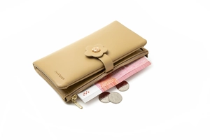 Macro detail of brown long wallet showing flower buckle and interior money slots