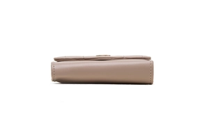 Detail view showing the layered folding structure and stitching of the pink leather wallet