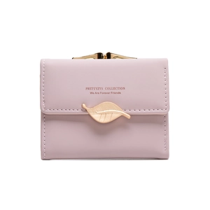 Close-up of pink women's wallet featuring a golden leaf buckle and metal frame closure