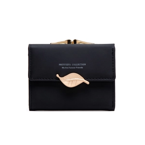 Detail of black tri-fold wallet featuring gold leaf buckle and retro metal frame closure