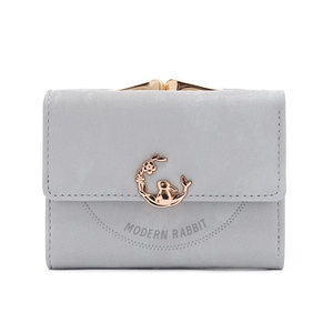 Detail of grey matte leather wallet featuring golden rabbit emblem and kiss-lock closure
