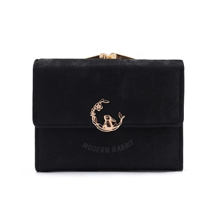 Close-up of black matte wallet with golden rabbit emblem and kiss-lock closure detail