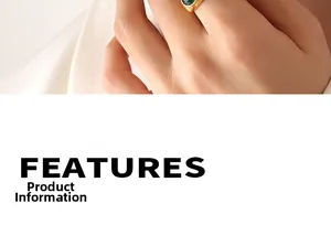 Detail of a gold ring with a large emerald green teardrop gemstone inlay for women