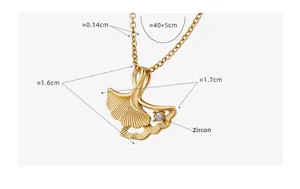 Detail view of gold ginkgo leaf pendant necklace with zircon and dimensions 1.6x1.7cm