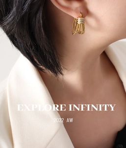 Detail of gold serpent chain earrings with cubic zirconia inlay on elegant model