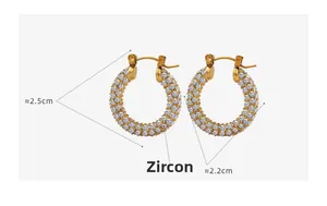 Detail view of U-shaped gold earrings with paved white zircons and dimensions 2.5cm