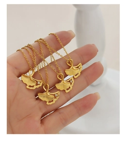 Detail of four gold ginkgo leaf necklaces with centered rhinestones on delicate chains