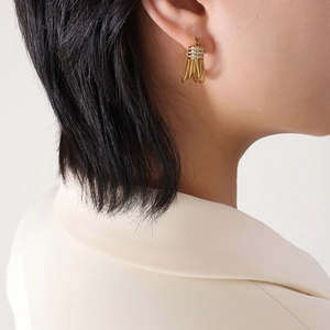 Elegant gold fringe earrings with zircon inlay and snake chain tassels shown on model