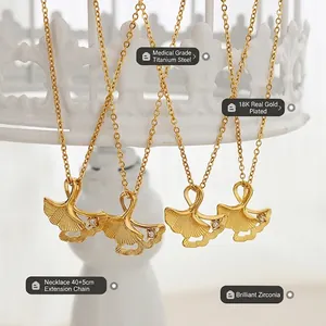 Gold ginkgo leaf pendant necklace in 18K plated titanium steel with zircon stone