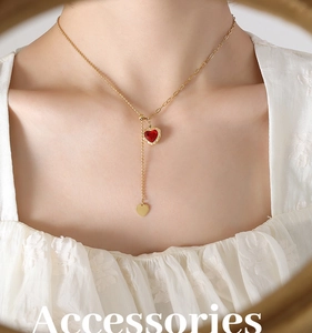 Detailed view of an adjustable Y-shaped gold necklace with a red heart zircon pendant
