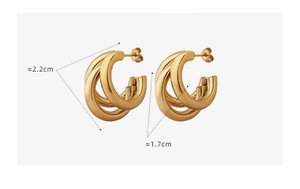 Detail view of triple layered C-shaped chunky gold hoops with dimensions 2.2cm by 1.7cm
