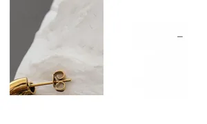 Detailed close-up of gold-plated triple-layer C-shape hoop earring post and butterfly clasp
