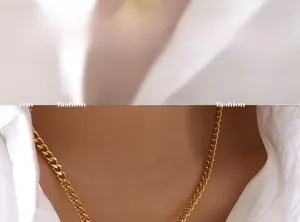 Close-up of a gold-plated Cuban chain necklace with a heart pendant on a female model