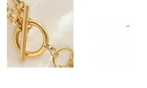 Macro detail of gold plated Cuban chain necklace with a classic vintage OT toggle clasp