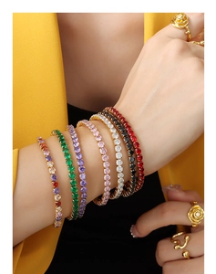 Detail of 18K gold-plated tennis bracelets with colorful zircons on a model's wrist