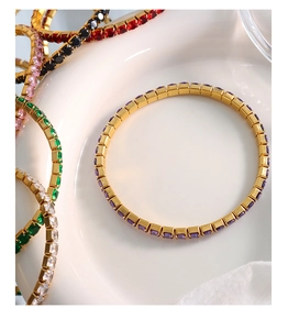 Detail of tennis bracelets with multicolor square-cut stones in 18K gold-plated settings